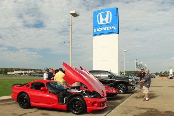red sports car in a Honda car lot
