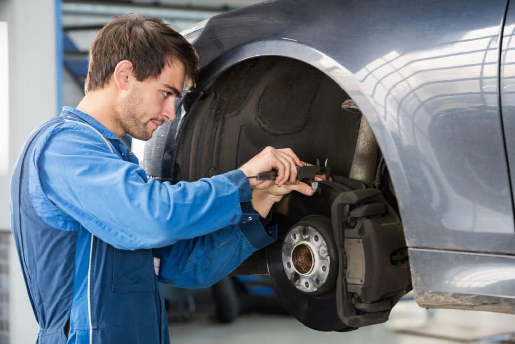 Technician explaining brake service recommendations to a customer